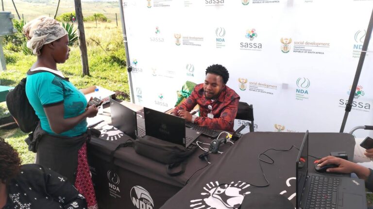 SASSA official assists applicant with online social grant registration at rural outreach desk, Apply for SASSA Social Grants June 2025 Application