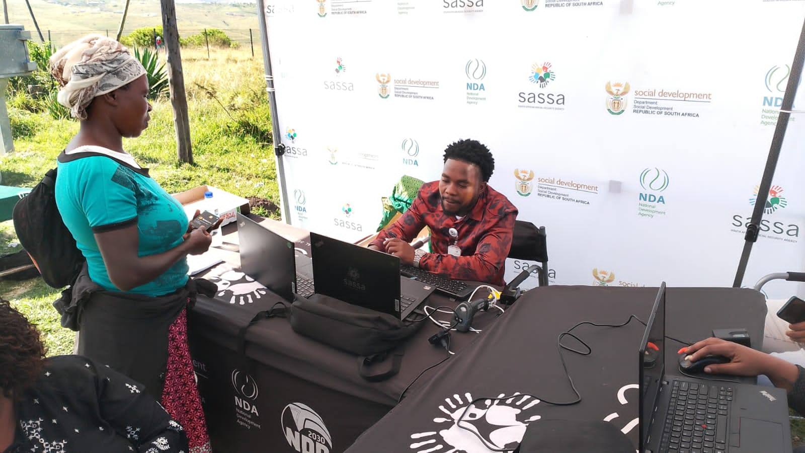 SASSA official assists applicant with online social grant registration at rural outreach desk, Apply for SASSA Social Grants June 2025 Application
