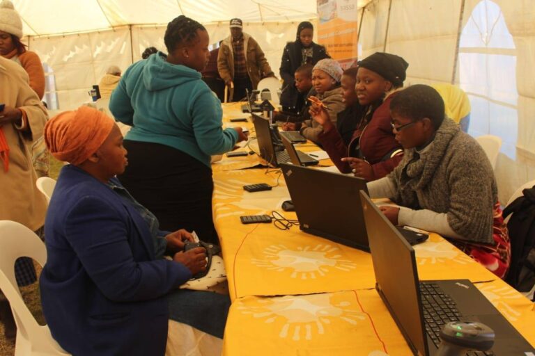Beneficiaries checking their SASSA R350 status for June 2025 payments at a local SASSA office, How to Check Your SASSA R350 Status for June 2025 Payment