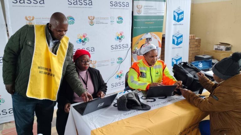 SASSA officials assist a beneficiary in updating banking details at a community outreach service point, How to Update Your Banking Details for June 2025 SASSA Payments