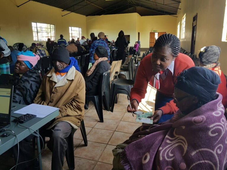 An elderly beneficiary is verifying the identity documents during the May 2025 verification process at a local SASSA office