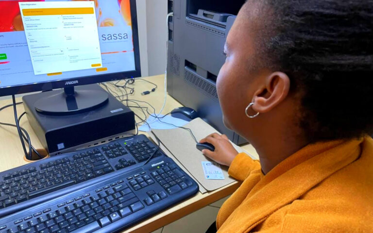 A woman is applying for a SASSA grant online using a computer, SASSA Opens SRD R370 Grant Applications for September 2025